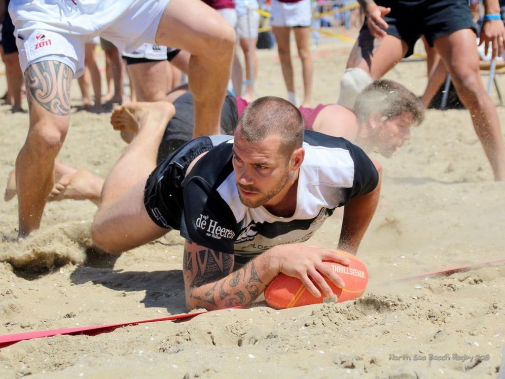 Oemoemenoe player scoring try at Beach Rugby at North Sea Beach Rugby in The Hague Beach Stadium in The Netherlands